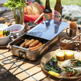 Family-friendly grilling setup shown on a patio during a sunny weekend