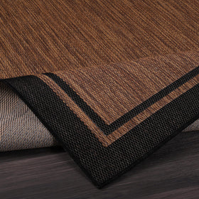 CAMILSON deck rug in nut brown and black border for outdoor living spaces