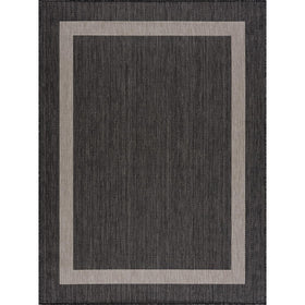 CAMILSON outdoor rug with light gray border enhances balcony comfort and quick cleanup.