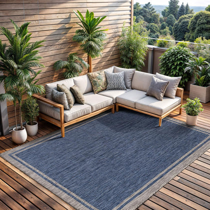 CAMILSON outdoor rug bordered navy 6x9 enhances patio style with durable construction.