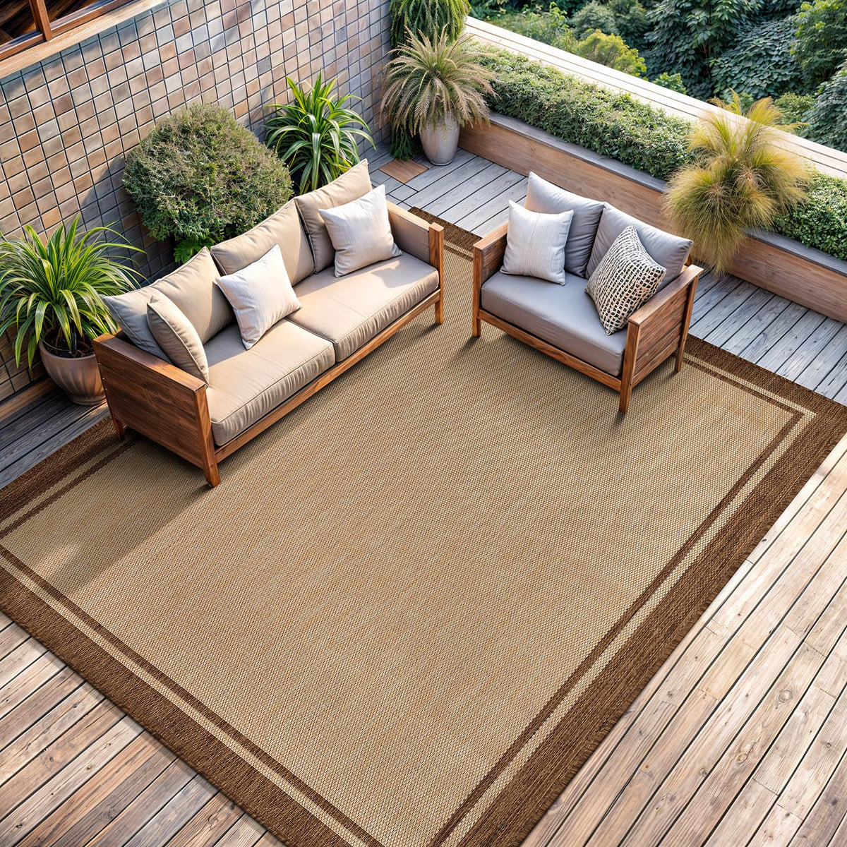 CAMILSON bordered natural brown rug complements neutral decor and outdoor furniture.