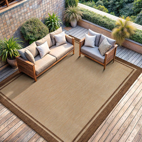 CAMILSON bordered natural brown rug complements neutral decor and outdoor furniture.