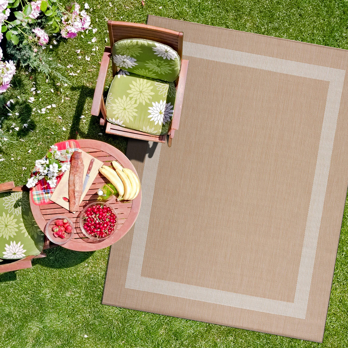CAMILSON lightweight outdoor rug rolled on deck for easy repositioning.