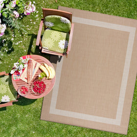 CAMILSON lightweight outdoor rug rolled on deck for easy repositioning.