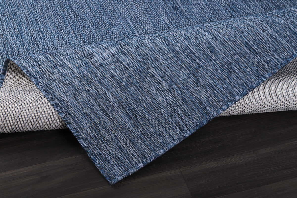 CAMILSON UV-protected rug, navy shade, shielding floors from sun and dirt.
