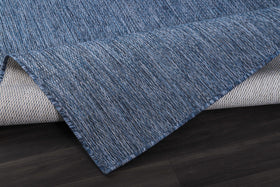 CAMILSON UV-protected rug, navy shade, shielding floors from sun and dirt.