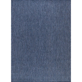 CAMILSON navy outdoor rug on balcony, UV-protected and stain-resistant for outdoor living.