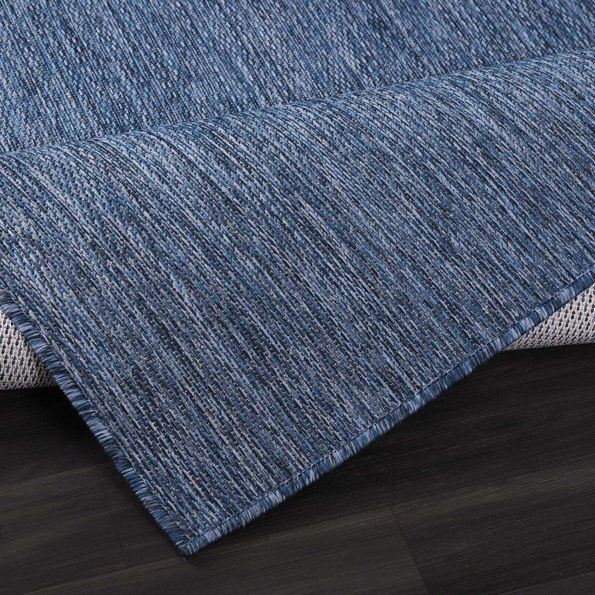 CAMILSON navy blue outdoor rug, lightweight and easy to move between spaces.