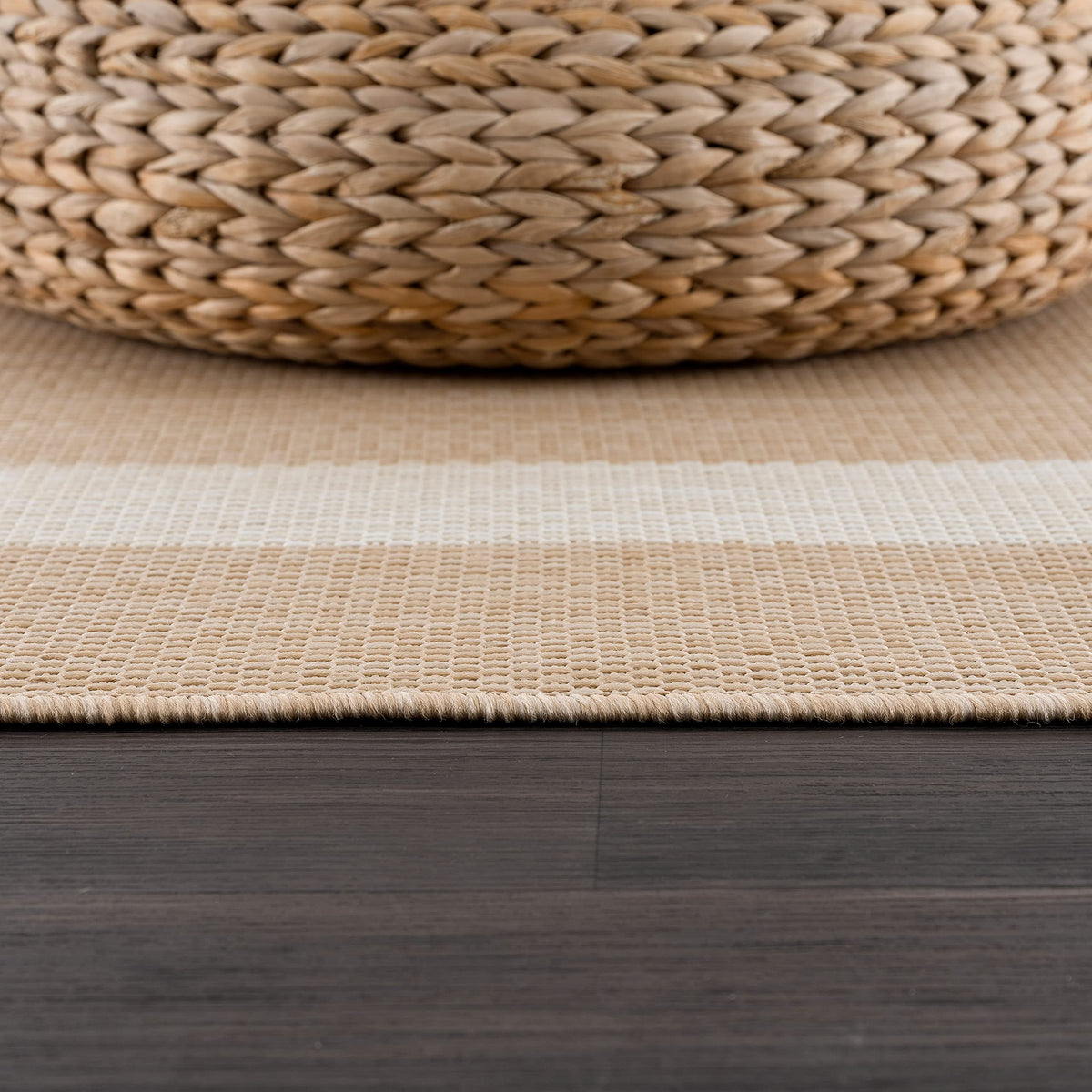 CAMILSON washable outdoor rug being hose-cleaned for quick cleanup.