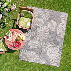 CAMILSON beige patio-outdoor rug shown in outdoor setting emphasizes UV protection and fade resistance.