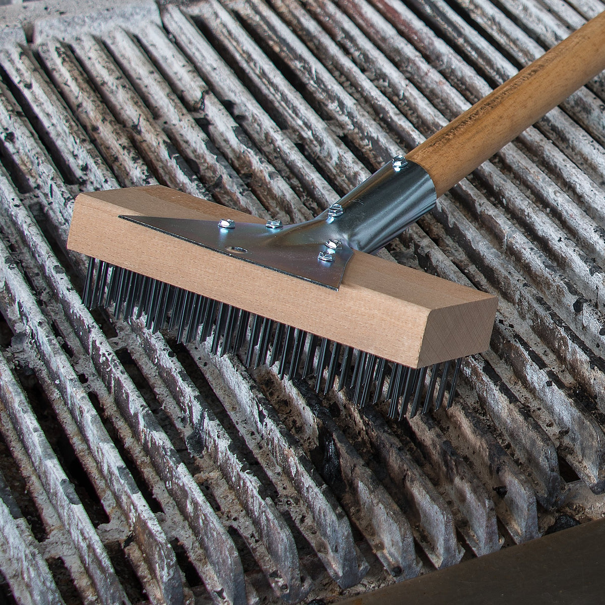 Carlisle heavy-duty tool in use on grill cleanup.