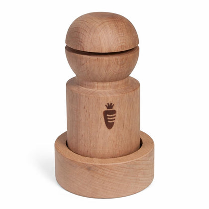 Carrot Design newspaper pot maker handle in use for shaping biodegradable seed starter pots.