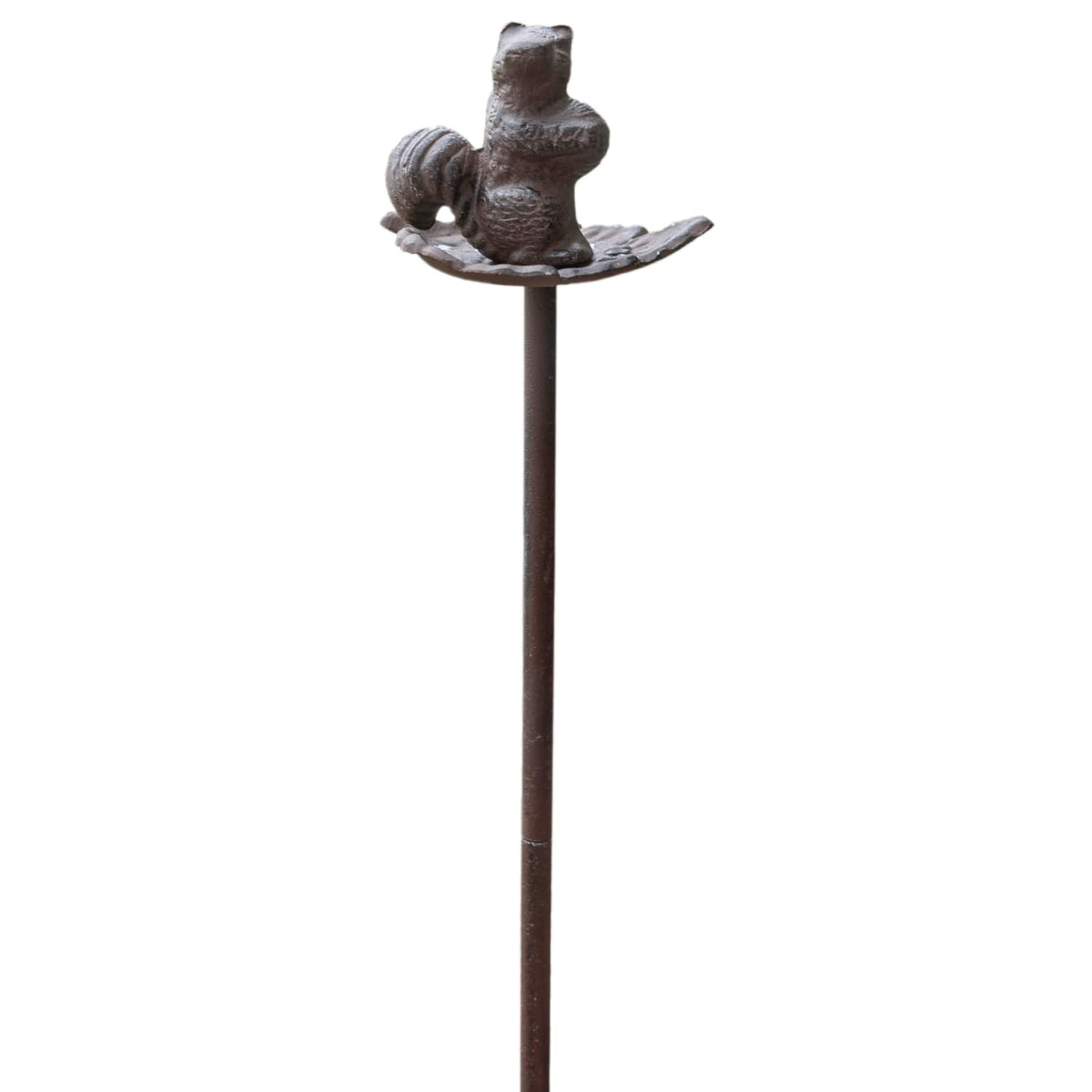 Carver's Olde Iron squirrel hose guide stake keeps hoses neatly routed around a flower bed.