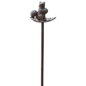 Carver's Olde Iron squirrel hose guide stake keeps hoses neatly routed around a flower bed.