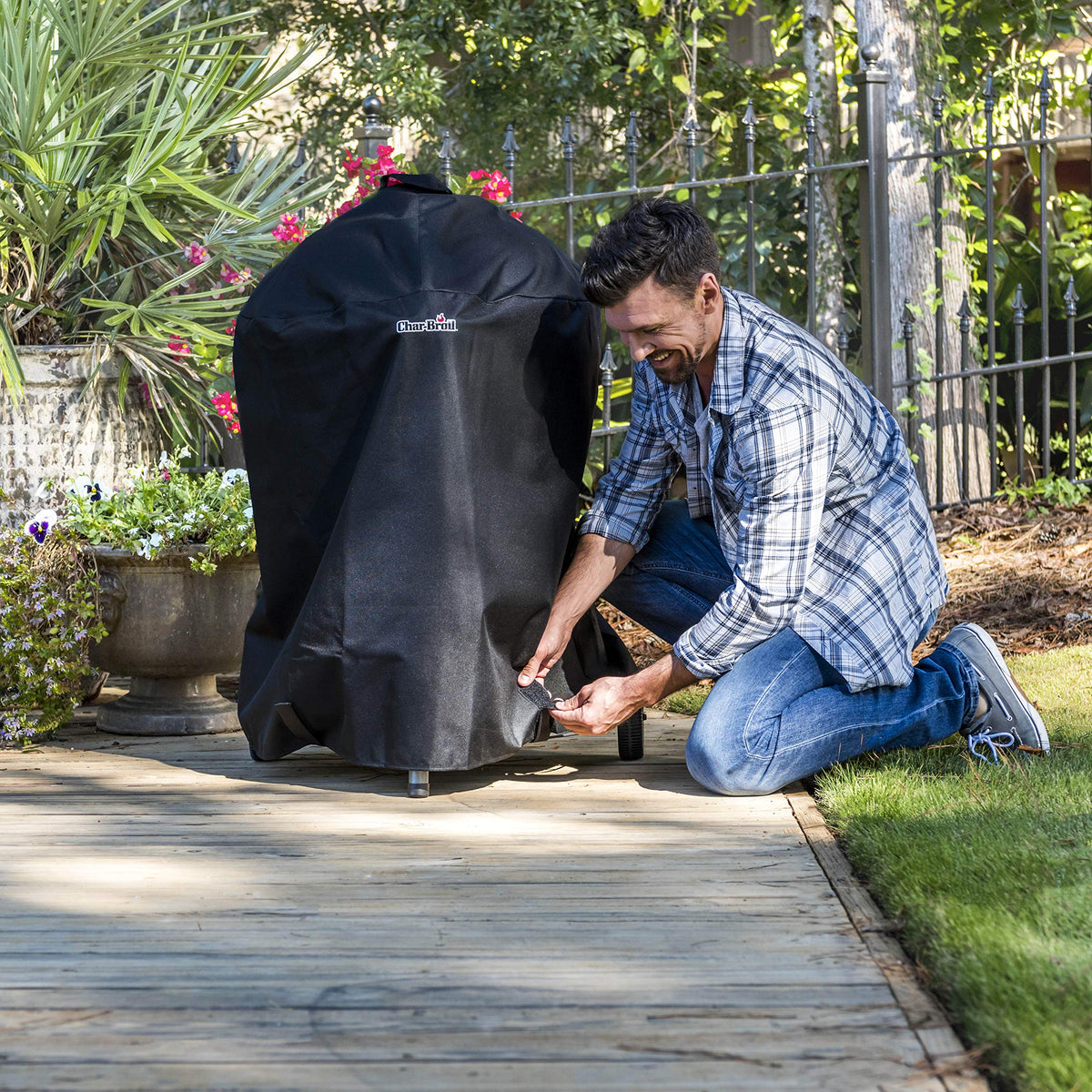 Char-Broil Kettleman cover on a grill demonstrates weatherproof protection for outdoor use