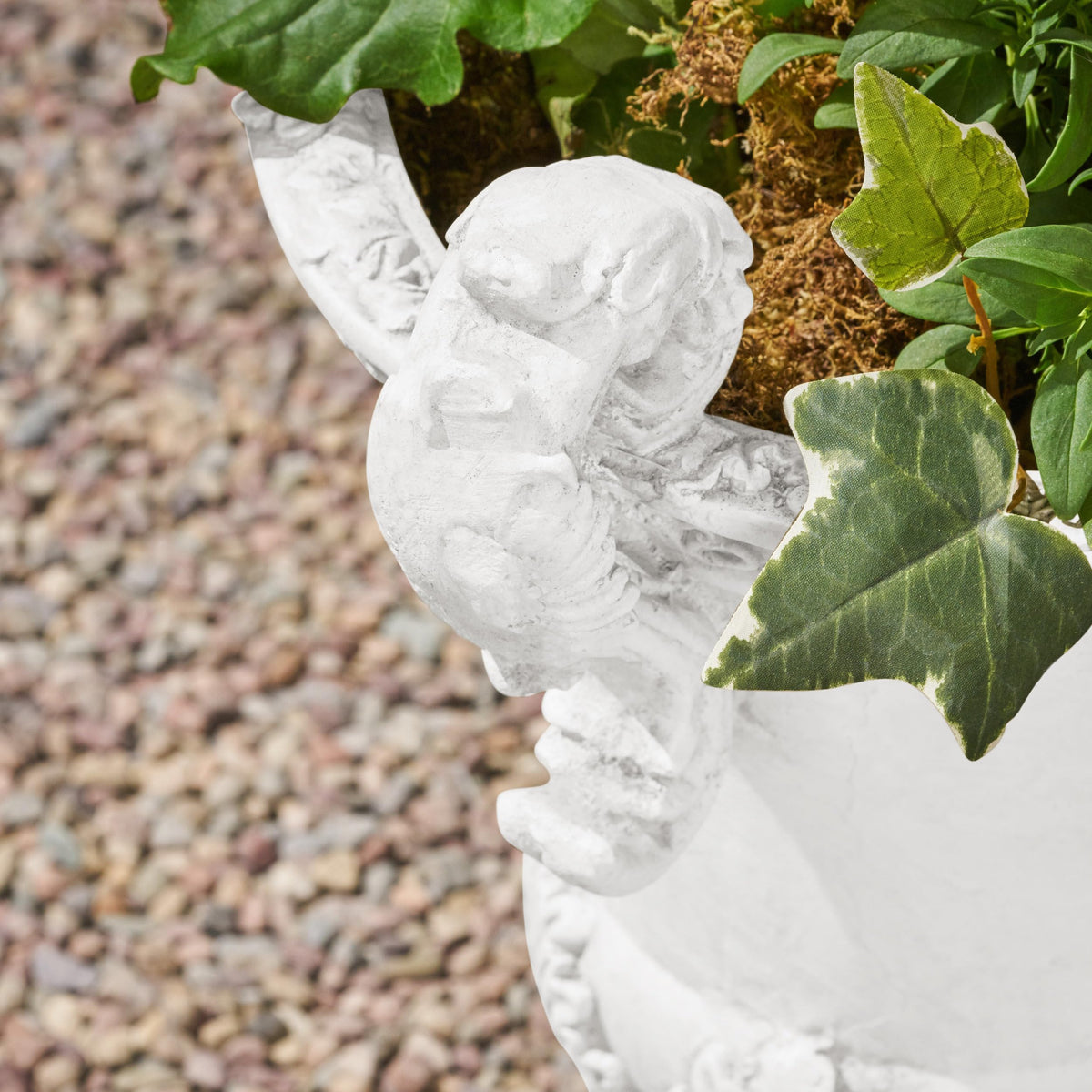 Weather-resistant Jorine planter withstands sun and rain for year-round display.