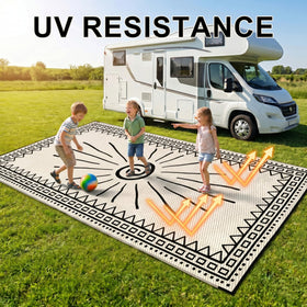 CircleRoad RV Outdoor Rug 9x12 with stakes securing a dry picnic area.