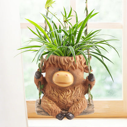 CIYSHO Swing Highland Cow planter hanging, adds whimsy and supports compact succulents.