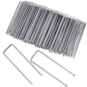 Clevich 6-inch galvanized landscape staples securing soil and fabric with a strong hold.