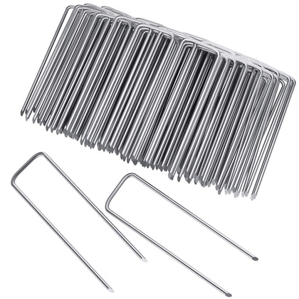 Clevich 6-inch galvanized landscape staples securing soil and fabric with a strong hold.
