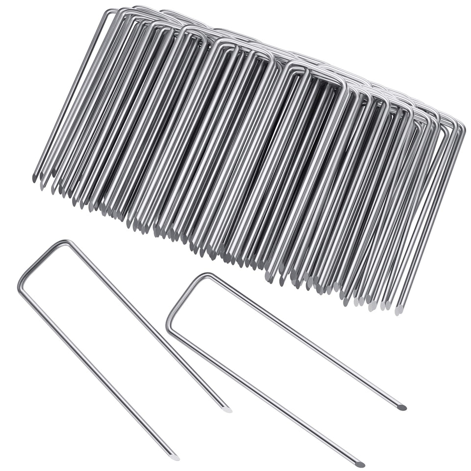 Clevich 6-inch galvanized landscape staples securing soil and fabric with a strong hold.