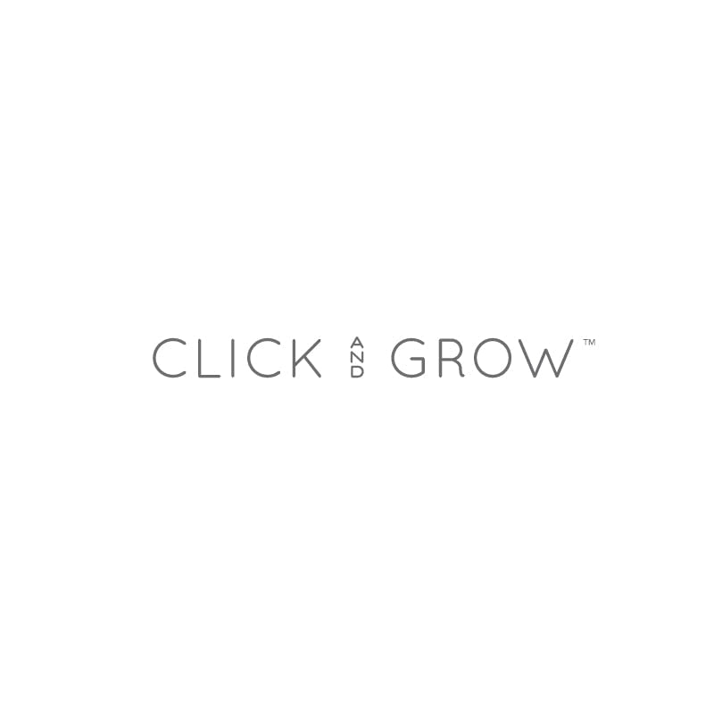 Click and Grow chili plant with flowers and red peppers ready to harvest.