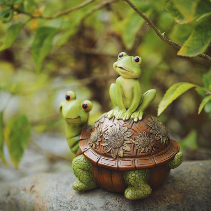 Cmrweio frog-on-tortoise garden statue enhances pondside charm.