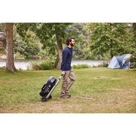 Coleman RoadTrip 285 portability-ready with compact legs for camping setups.