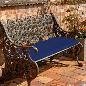 Comcaver navy cushion shown on a backyard patio