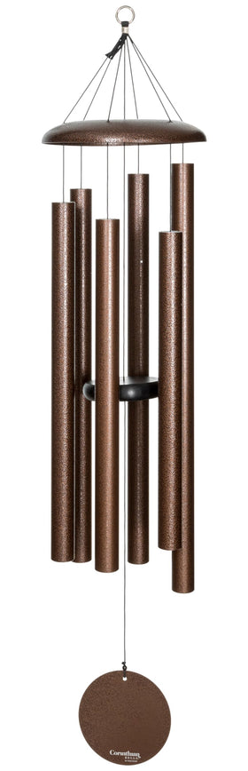Corinthian Bells 50-inch copper vein wind chime hanging on a porch, adding deep outdoor ambiance.