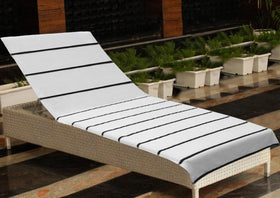 COTTON CRAFT striped cover by poolside in bright sun.