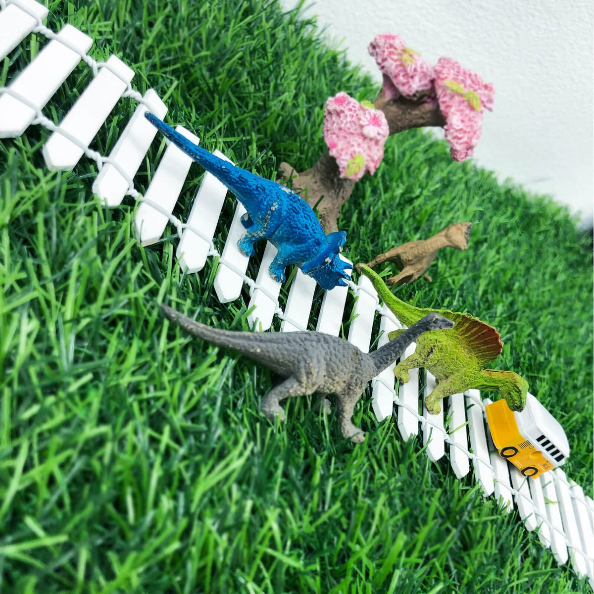 CozyCove yard decor fence adds charm to planters.