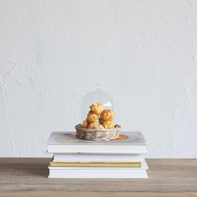Creative Co-Op cloche with willow base ideal for centerpieces and table accents.