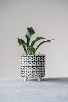 Creative Co-Op round stoneware planter with black and white finish, elevating spaces indoors or outdoors.