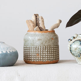 Creative Co-Op terra-cotta round planter on a wooden surface for rustic styling.