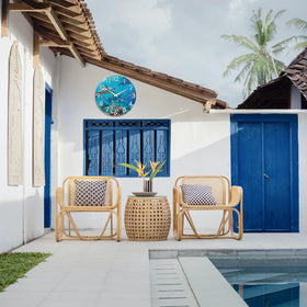 Crosstime coastal outdoor clock complements shiplap and tropical landscaping.