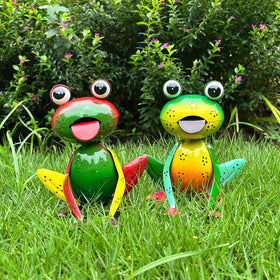 Cruis Cuka metal frogs brighten the outdoor garden with cheerful yellow-green eyes.