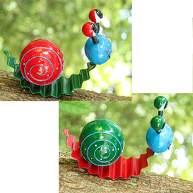 Cruis Cuka snail garden decor in a flower bed for curb appeal