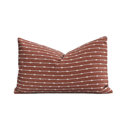 Crumbs Home front embroidery on rust linen lumbar pillow cover for indoor-outdoor use.