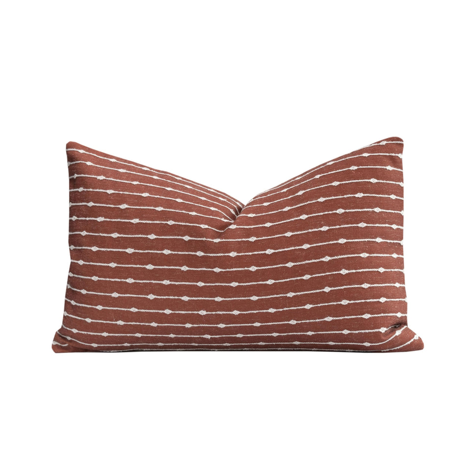 Crumbs Home front embroidery on rust linen lumbar pillow cover for indoor-outdoor use.