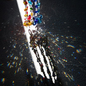 Crystalsuncatcher rainbow prism in sunlight refracts vivid colors across walls.