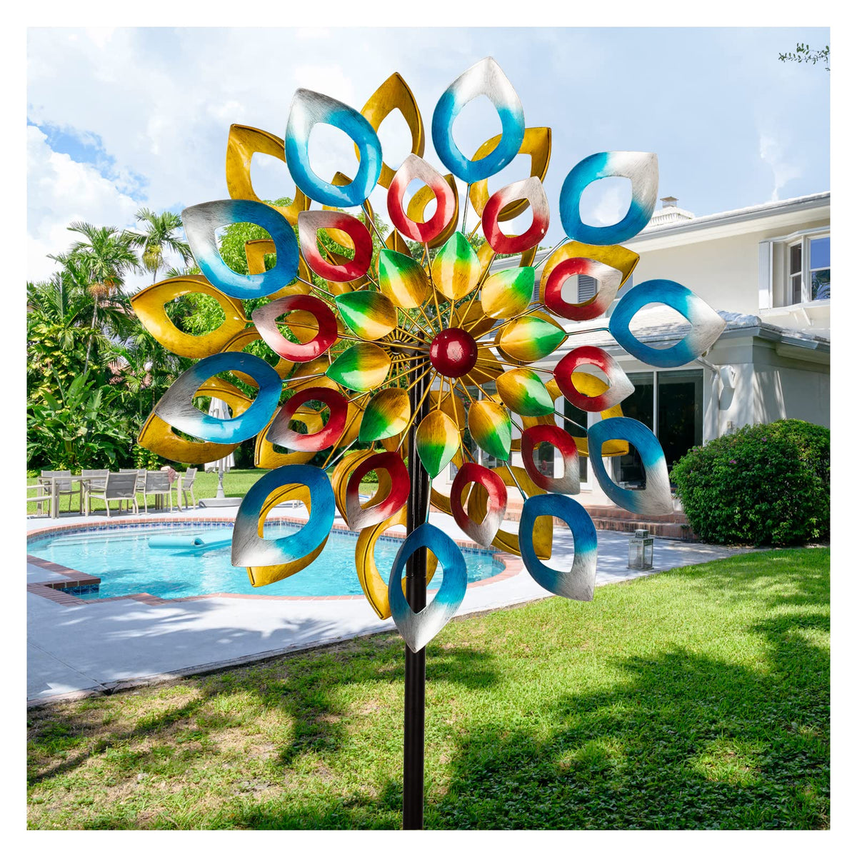 Cyan Oasis wind spinners on stake add dynamic garden decor in sunlight.