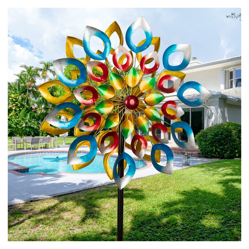 Cyan Oasis wind spinners on stake add dynamic garden decor in sunlight.