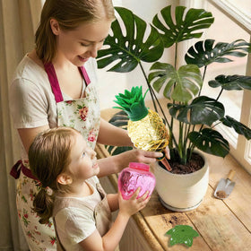 Cynevaris strawberry watering globe providing consistent hydration to plant roots