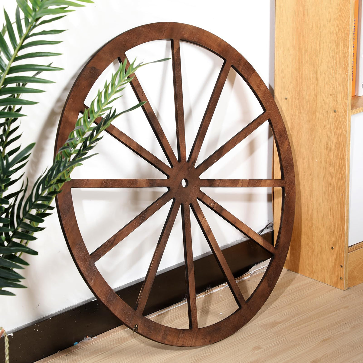 DaisyInner brown wood wagon wheel adds warm texture to outdoor spaces.