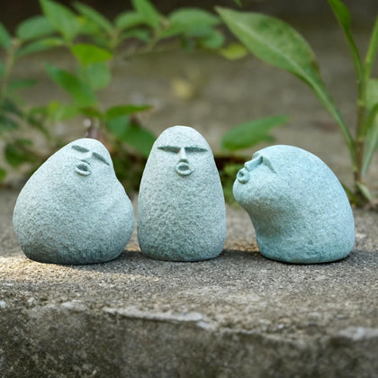 Daisylily stone man figurine set on display in garden for playful outdoor charm.