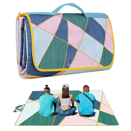 DanCoom picnic blanket unfolded on grass, spacious 59 by 79 inches for family seating