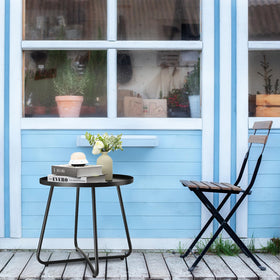 danpinera outdoor side table two-pack used as plant stand in garden.