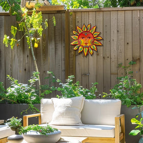 Daogtc sun wall decor in a garden setting adds warmth outside.