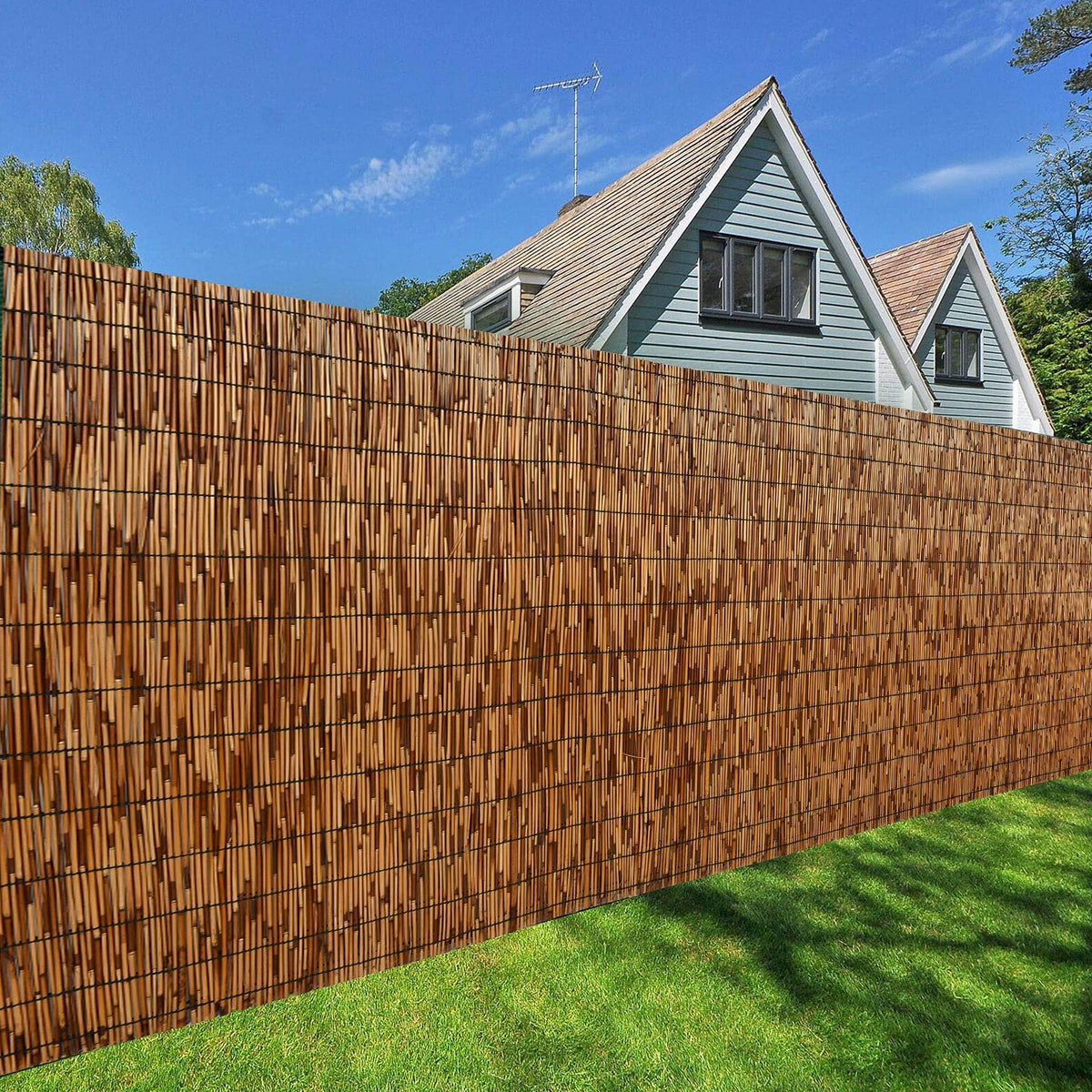 DearHouse reed fence weathered look blends with exterior environments.